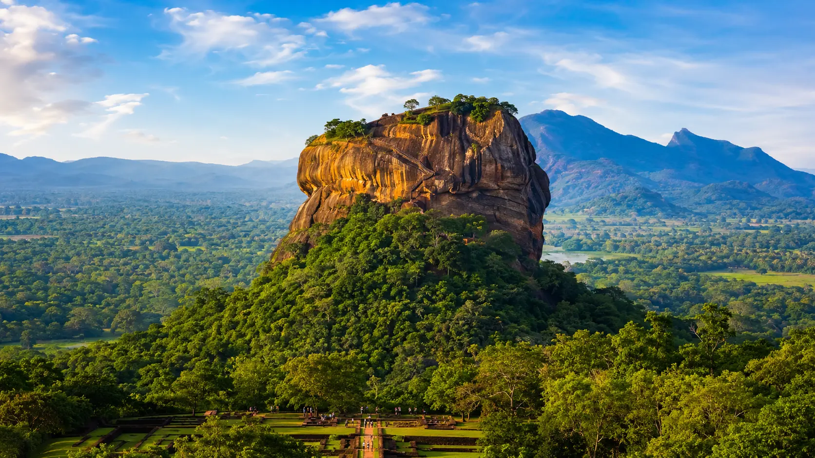 Sigiriya Rock surrounded by lush tropical landscape in Sri Lanka